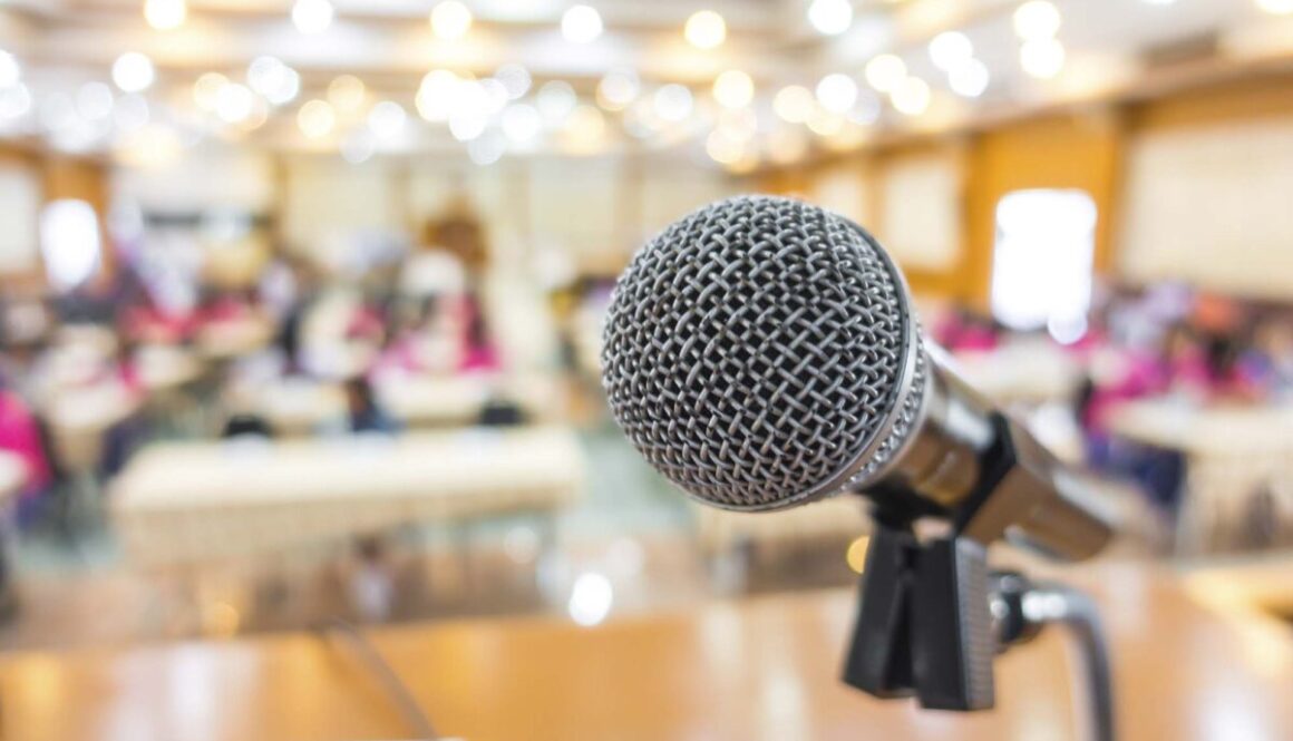 Black microphone in conference room .